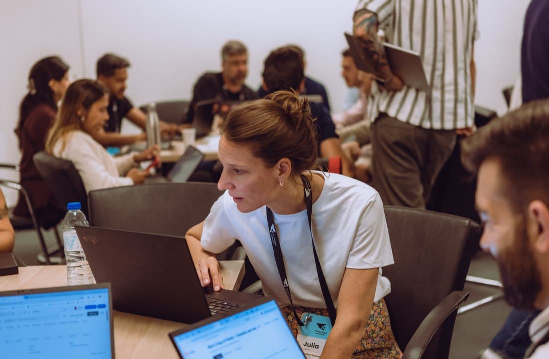 A participant focused on building a prototype on her laptop